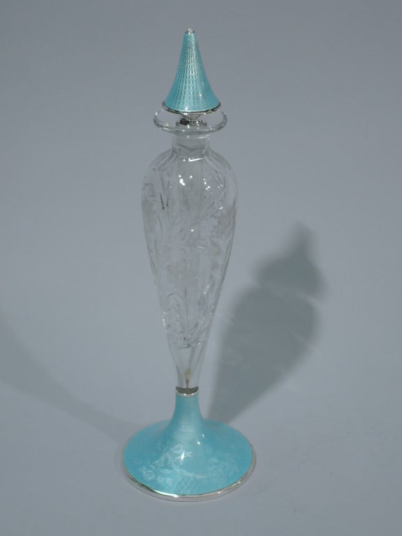 American crystal perfume with sterling silver and enamel foot and stopper, ca. 1915. Bottle is baluster with cut and acid-etched flowers and foliage. Foot is raised with blue enamel garland on engine-turned ground. Foot rim and underside are silver.