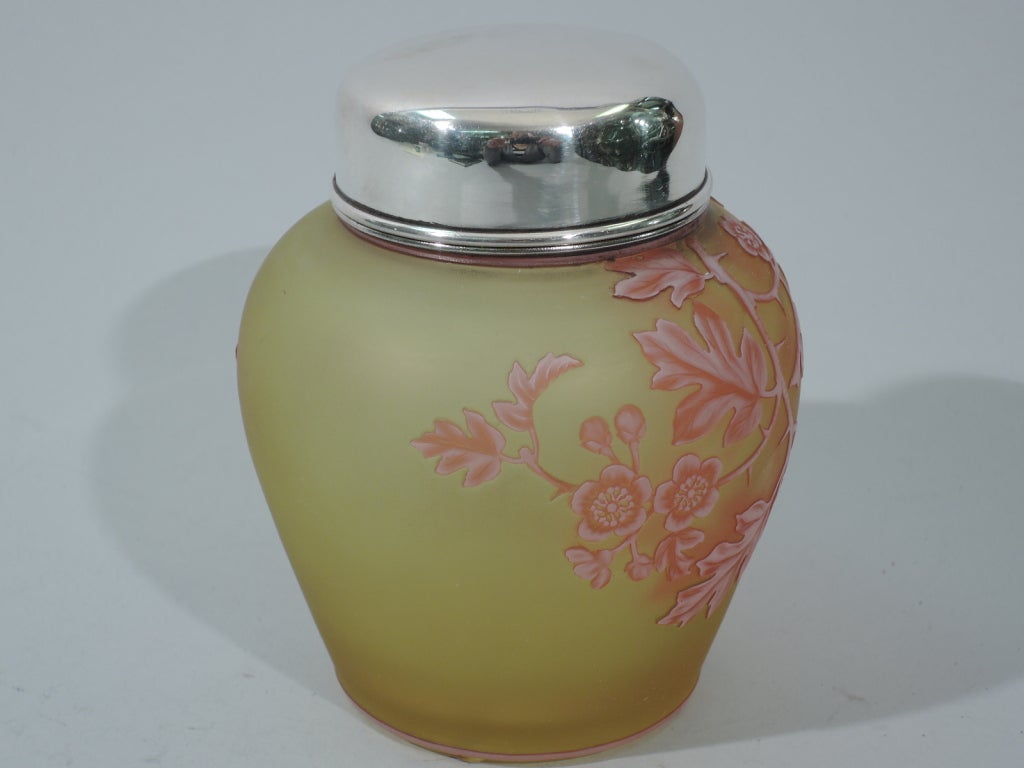 Citrine cameo glass tea caddy with sterling silver collar and cover, ca. 1900. The glass was made by Thomas Webb & Sons in England. The silver was made by Gorham in Providence, Rhode Island. Ginger jar form with baluster body and short neck.