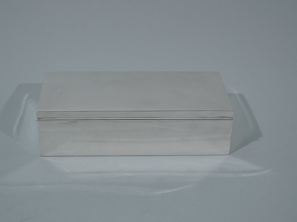 Sterling silver desk box. Made by Tiffany in New York, ca. 1913. Rectangular with crisp corners. The cover is hinged and curved with molded rim. Box interior cedar lined. The pattern (no. 18495) was first produced in 1913. 

Dimensions: H 2 x W 7