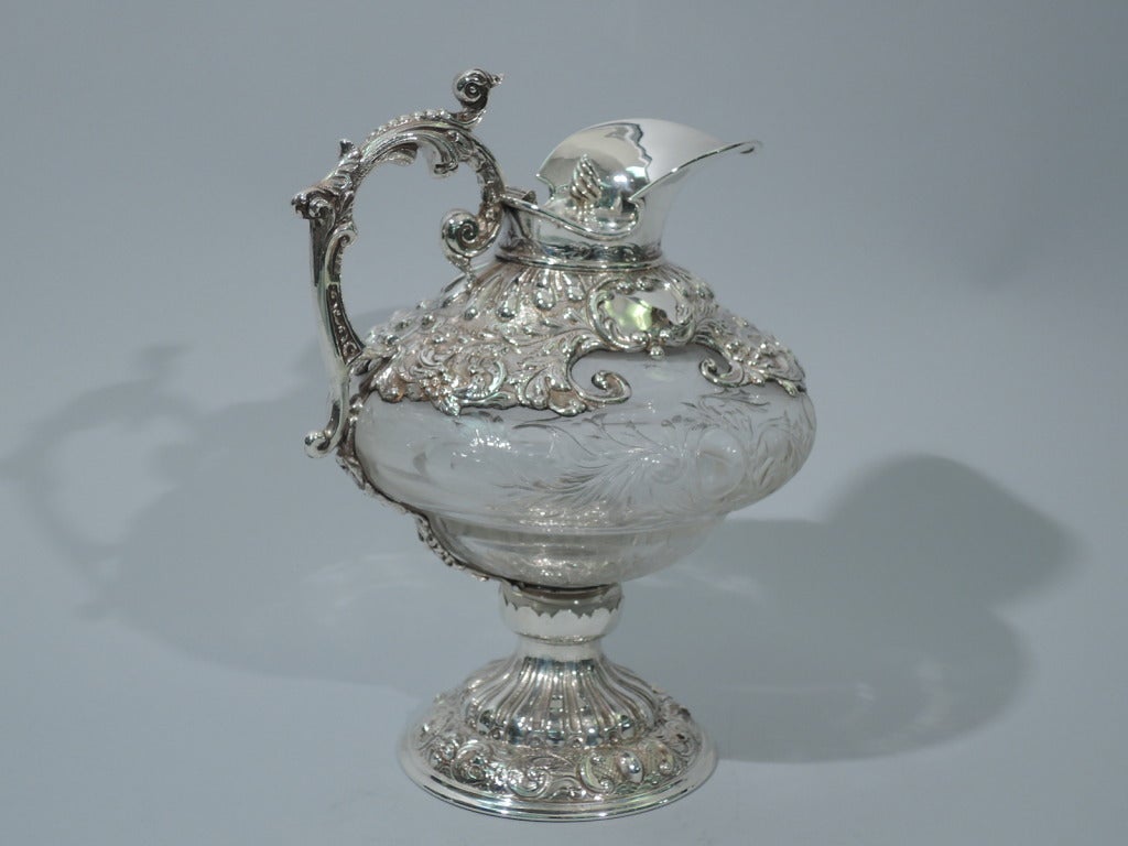 George V etched-crystal decanter with sterling silver mounts. Made by Charles Edwards in London in 1916. Squat and curved decanter with etched foliate ornament, including 2 vacant cartouches. Silver dome foot with repousse gadrooning and scrolls.