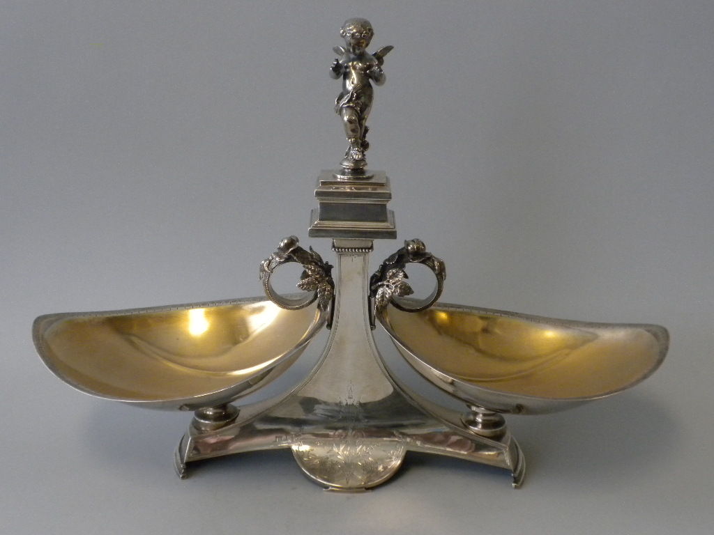 This stately Antique American Sterling Silver Centerpiece was made by Gorham Mfg. Co. of Providence, RI, and is dated 1872.  This sophisticated 19th Century centerpiece is designed with a delicately engraved pedestal base supporting two leaf shaped