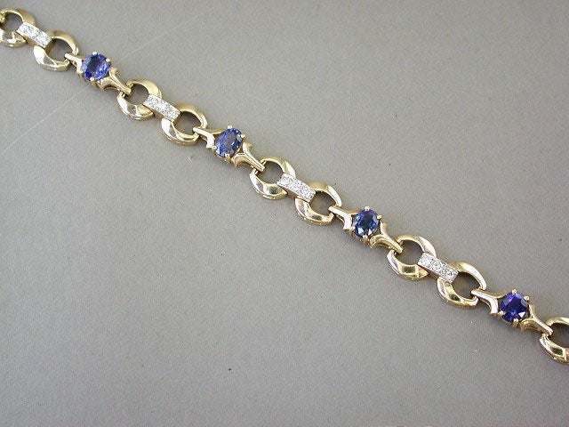 14kt yellow gold link w/3-stone diamond connecters and 5 oval, faceted sapphires, approx. 5.80cts, by Tiffany