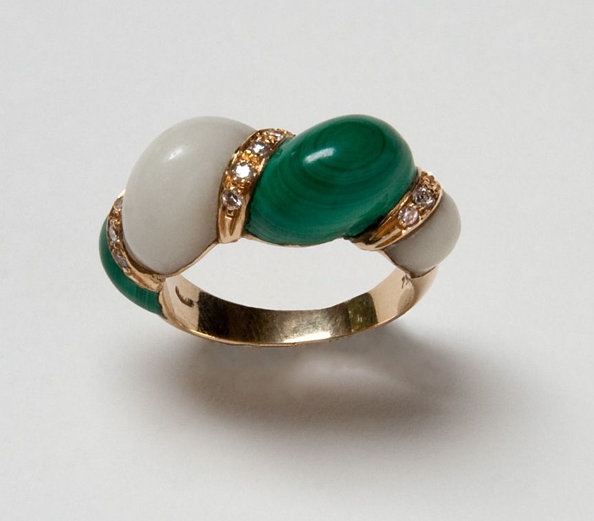 A sensuous shrimp ring of malachite, white coral and brilliant cut diamonds set in 18 karat yellow gold, size 8.25, may be sized slightly.