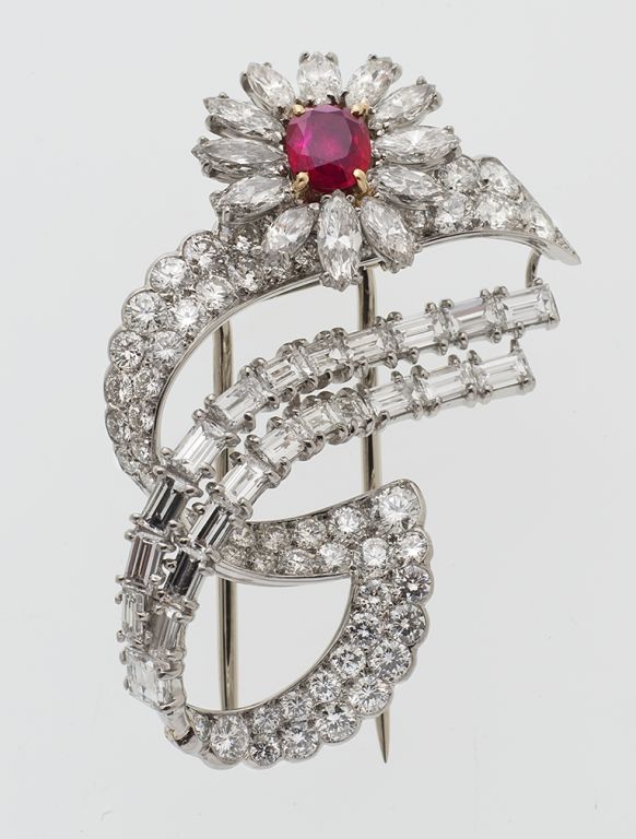 This ruby and diamond brooch could only be by Cartier.  The sweep of the lines, juxtaposition of the shapes, use of negative space and the elegance with which all of this is accomplished indicates great artistry.   Signed Cartier Paris, numbered,