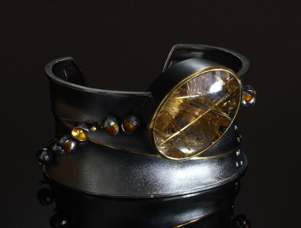 35mm Anticlastic oxidized sterling cuff with a rutilated quartz (58.66ct, 35x25mm) and sterling/22kyg flourishing elements with 18kyg beads & 18kyg gold wire on chased pattern and diamonds (0.20ct tw)