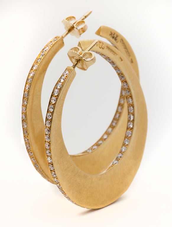 Superbly crafted contemporary diamond hoop earrings in 22 karat yellow gold designed by Andrea Lieberman for Mouawad. Beautiful new moon shaped hoop earrings narrow at the earlobe and broaden into a wider gold swath at the bottom most point. The