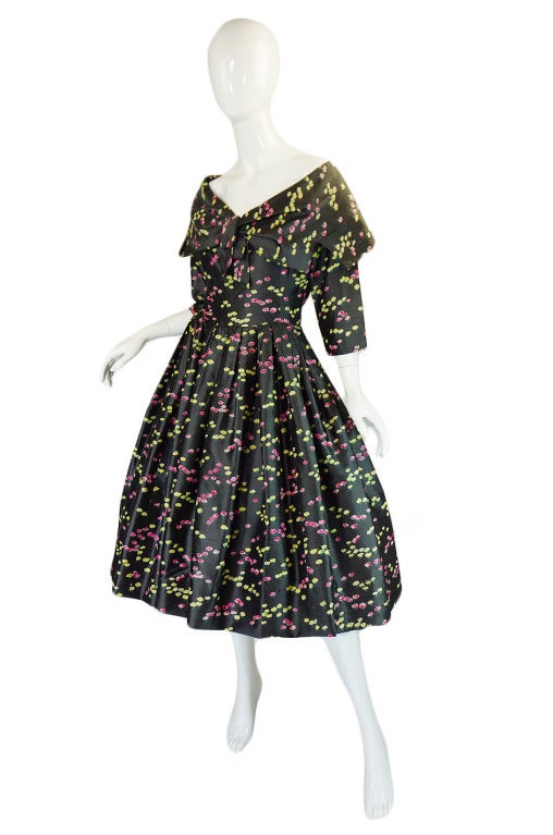 This is an amazing mid-fifties numbered silk Christian Dior London dress that was sold through Holt Renfrew. The dress is so representative of that time period for the house of Dior. The 
