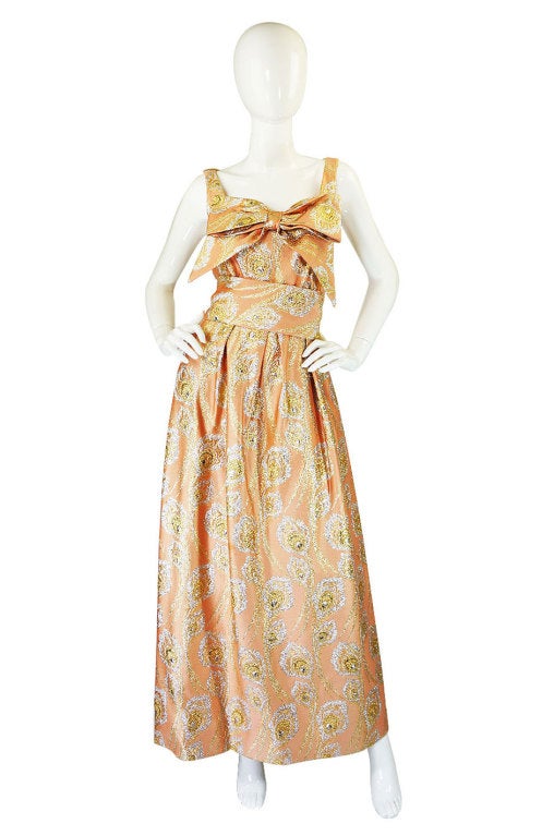 Oddly I just had what would have been the sister to this gown a few weeks ago - same fabric but with a slightly different bust! I absolutely love the color of this piece - it's a rich combination of a silk peach base with a swirling design of gold