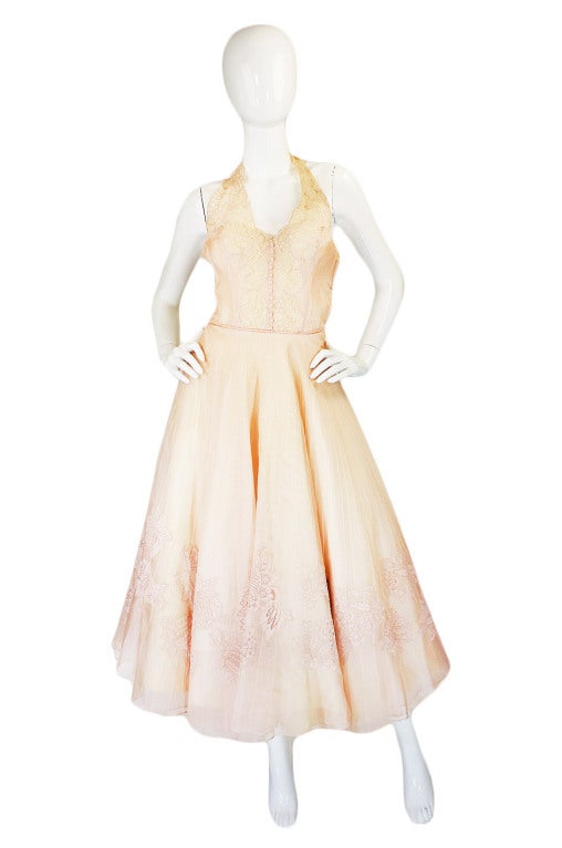 The softest palest, blush ballet slipper pink silk organza seems to float in layers of femininity on this wonderful dress. From tip to bottom the organza has been meticulously pin tucked into vertical rows that gradually widen as you near the hem of