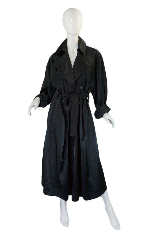 An amazing and very very rare over sized Alaia trench coat in a textured glossed nylon fabric by Azzedine Alaia. This piece captures the hey day pf the over-sized, voluminous movement of the 1980s perfectly! It s a play on the classic men's trench