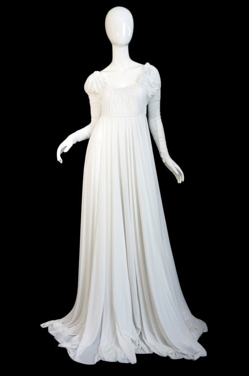 This OMO by Norma Kamali gown is a jewel! Supermodel length and made from yards and yards of pristine white, fluid jersey! It gives a strong nod to the turn of the century in style and has an amazing goddess feel. The skirt is a full 54