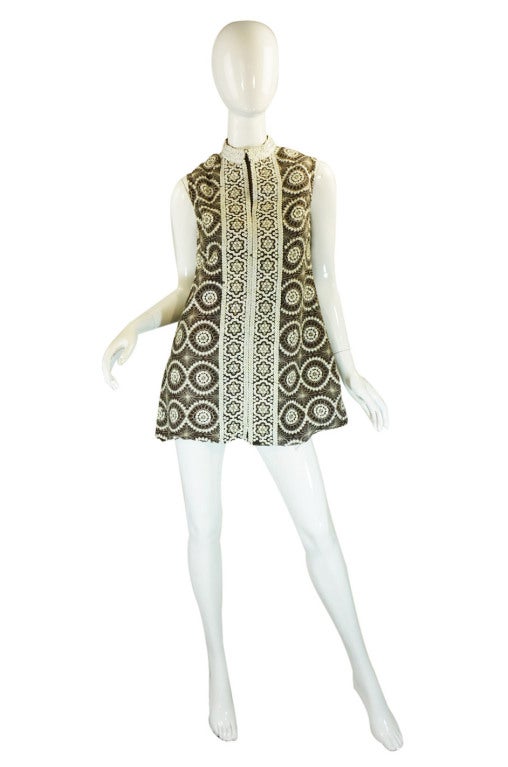 Am amazing and chic 1960s dress that perfectly captures the mood of the times. At first glance you think that the dress is only embroidered but that stunning patter is actually created by a combination of embroidery work mixed with white sequins