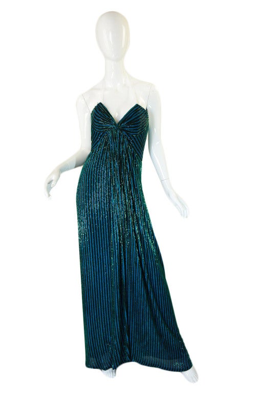 This is a stunning and rare gown designed by Bob Mackie who is best known for dressing Cher and for his love of opulence and bead work! He worked for both Edith Head and Jean Louis and I think he secretly always designed for the big screen and the