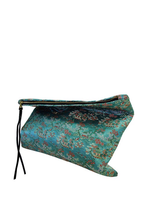 The fabric used for the exterior of this one of a kind day-to-evening clutch was taken from a very unique piece - the dress it was salvaged from was an original 1950s cheongsam and the fabric has a wonderful Asian flare! It has an almost metallic