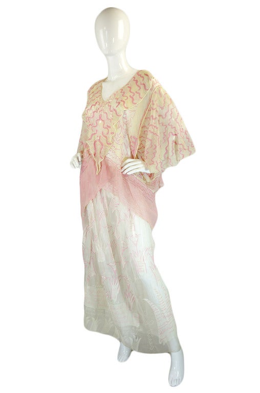 This two piece caftan feel set by the great Zandra Rhodes in not only rare but in museum level quality. It is constructed of a fine white silk chiffon that is entirely hand painted. (note that the top in some pics has a yellow tinge - that is