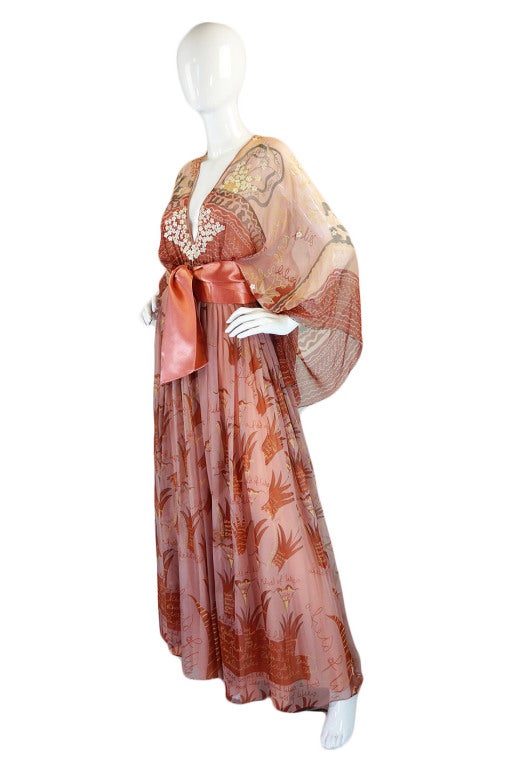 This rare and amazing hand painted silk caftan gown by the great Zandra Rhodes in not only rare and of museum level quality but its near twin is actually a permanent part of the Manchester Museum! (click here to view it on their site). It is