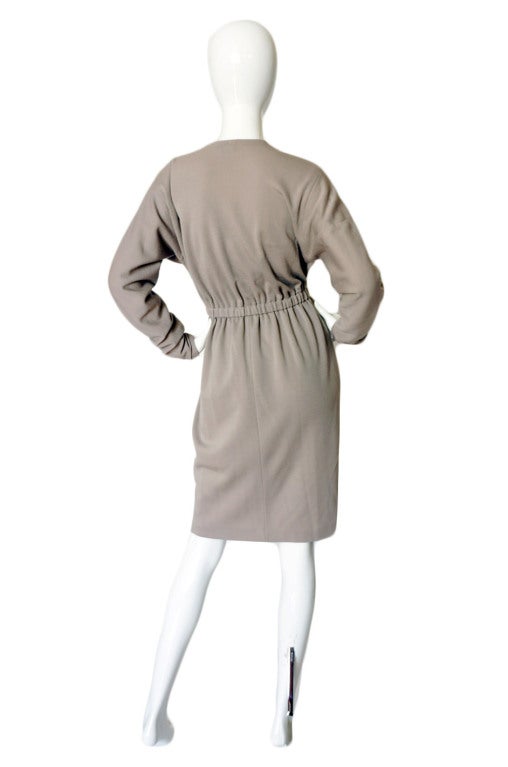 An amazing 1970s Halston in a rich grey taupe shape of a fine wool that has perhaps a touch of cashmere.This was one of his favorite fabric to use for day and the lines are also classically Halston. It is bias cut and with as little seaming as
