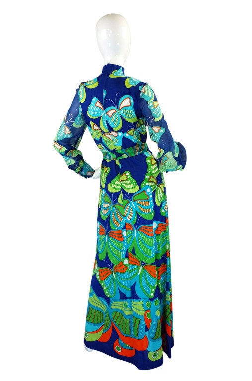 This dress is quite fabulous with it's huge butterfly print that is screened onto it form top to bottom and done in stunning shades of blue and green with pops of tangerine. The La Mendola label is highly collectible and sought after - when the duo