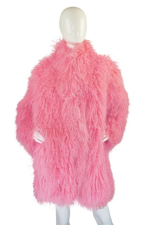 This is an insane and generously cut pink (!) Mongolian fur jacket form the seventies that is absolutely fabulous! I have seen many the Mongolian fur jackets but to find one that is a bubble gum shade of pink is something else! It appears to have