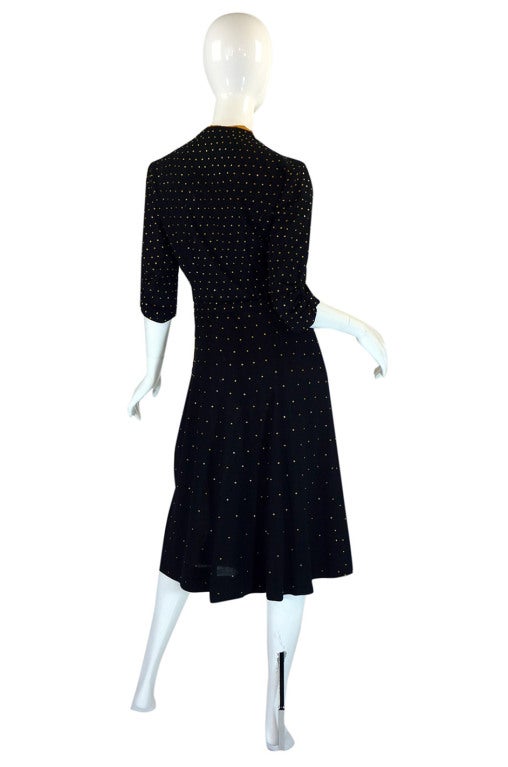 This dress is so fantastic I find it hard to begin and it is almost impossible to find these studded dresses from the 1940s anymore! The cut is simple in that perfect feminine forties kind of way  - the two tone bodice, simple short sleeves with