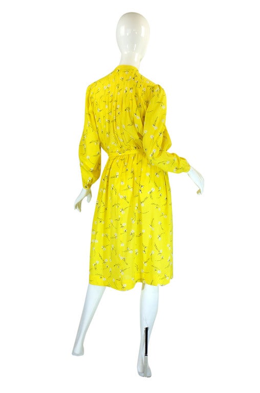 This is a lovely day dress in a lightweight cotton from Hanae Mori. The color is a bright lemon with a white and black floral pattern screened onto the fabric. It has a pretty and light feel to it and is quite adorable! The body is fairly loose