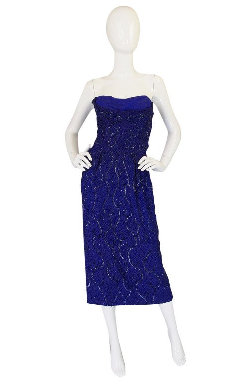This beautiful dress was created by Ceil Chapman who is often referred to as Marilyn Monroe's favorite designer. It is so beautiful in person and the level of detail put into the construction is wonderful. The dress is constructed from a blue silk