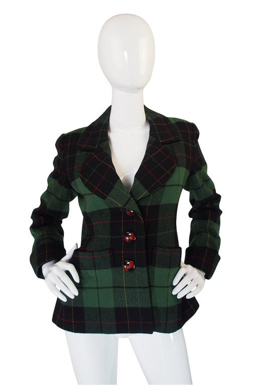 Green plaid YSL jacket with cuffed sleeves and front pockets. Love the custom wood buttons. No flaws

Ships professionally dry cleaned

approx size 6-8

Shoulders: 15