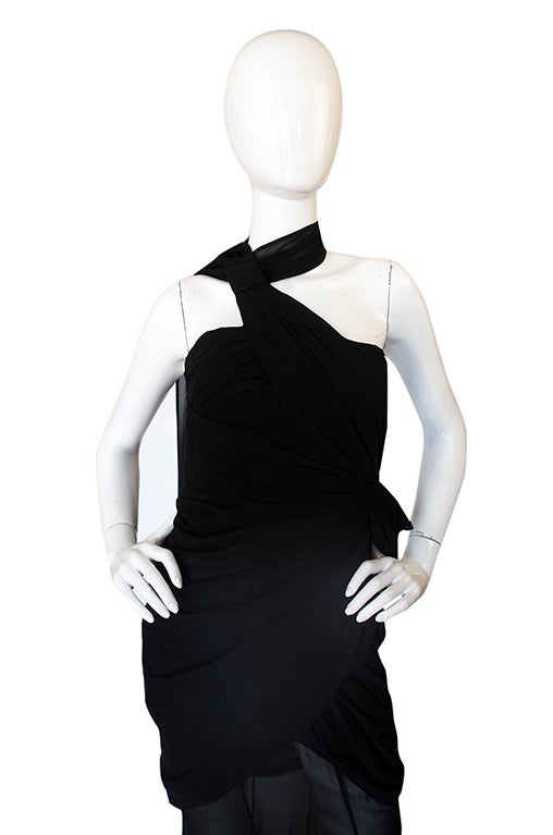 Shockingly sexy and brilliantly constructed this 1980s Thierry Mugler is a masterpiece of draping and cut. The entire bodice is wrapped around the wearer and has a more structured inner corset. It hugs and wraps the hips and then a cascade of sheer