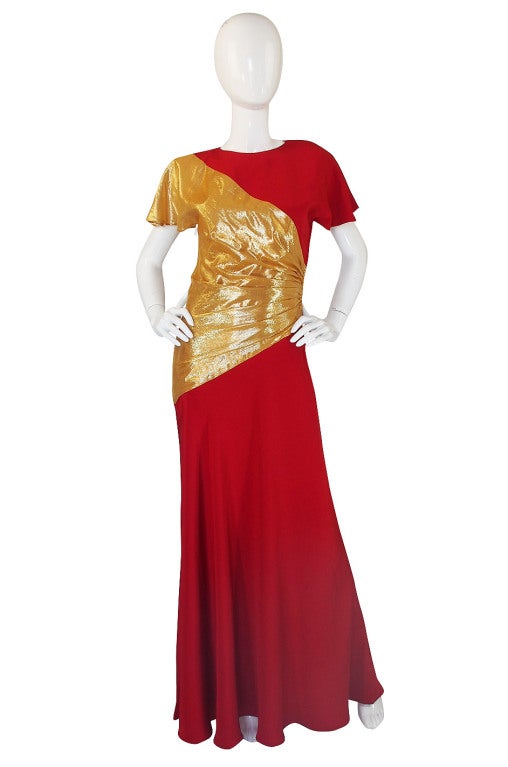 Bruce Oldfield is of course best known for dressing Lady Diana but has dressed countless other celebrity and women of influence. This is a stunning and dramatic gown made of a red silk and topped with a golf foil lame inset. The inset dramatically