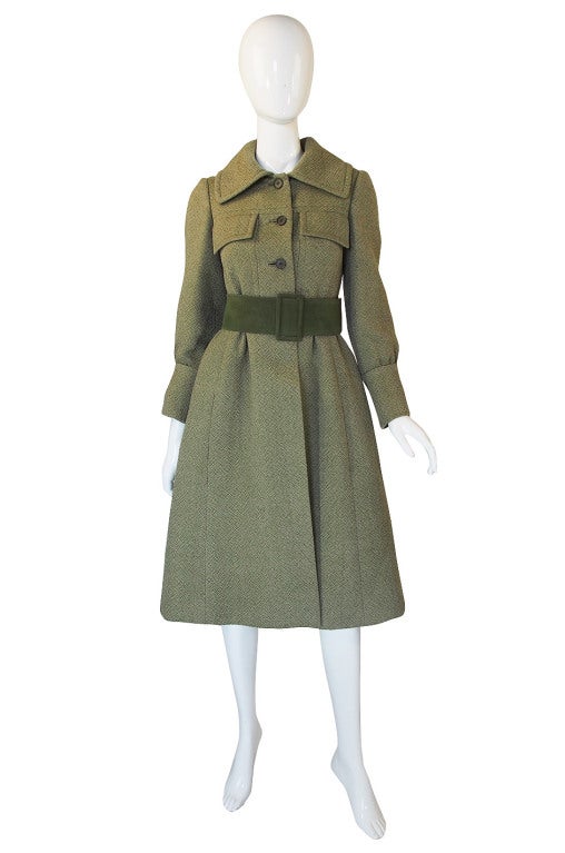 This is an excellent and rare example of Philippe Venet work. A fine wool is woven into a subltle herringbone pattern in a soft green. I love the princess cut full skirt and how the sleeves each have a slight pouf above the deep cuffs. Front flap