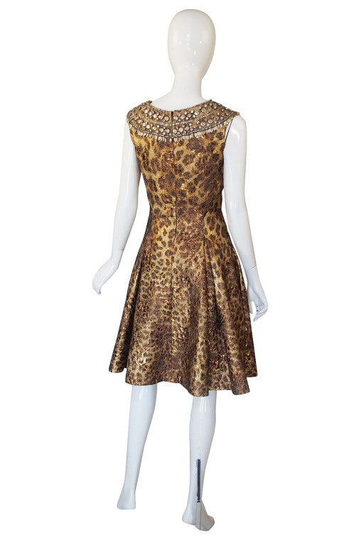 Though this is recent it has a decidedly vintage feel to it and is constructed to high standards! The exterior fabric is a silk brocade that is shot through with metallic thread so it has a subtle gleam to it. Onto this is a leopard print in hues