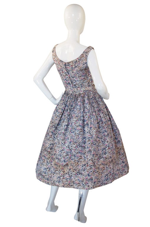 Made of a stunning printed silk taffeta with a custom design screened onto it. The front has a deep plunge built in sweetheart neckline that extend into straps that go over each shoulder. The waist is nipped in for that perfect hourglass silhouette.