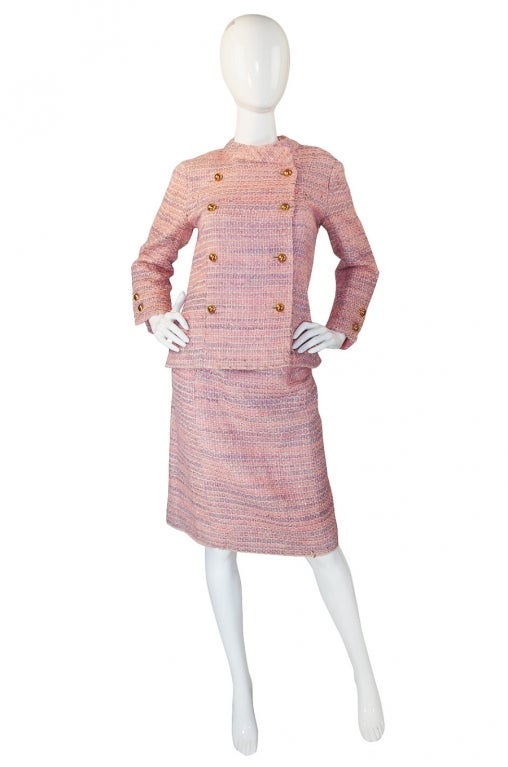 It is always wonderful to have a true piece of Haute Couture and this Chanel suit is to die! First of all, it is pink and a perfect pastel pink at that! It is the classic Chanel boucle that upon close inspection is actually a mix of a pink wool, a