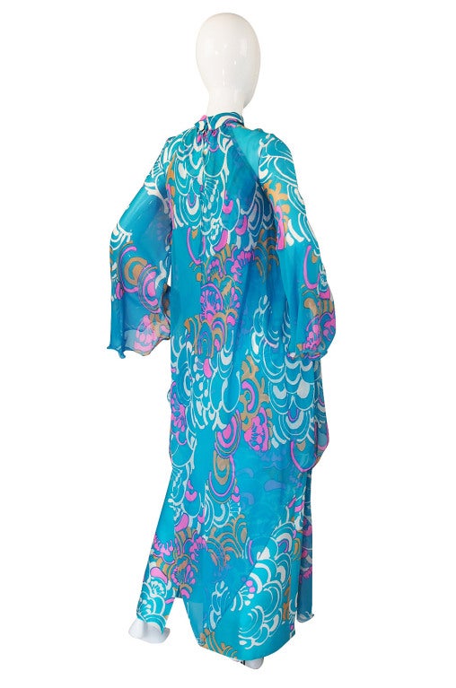 This is an incredible masterpiece by Hanae Mori and I will be quite sad to see it go! The color of the silk is a brilliant turquoise with vibrant pops of pink mixed with a taupe and a stark white. The effect is absolutely stunning, as is the