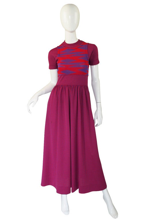 This is a tremendously fabulous example of Gernreich's work! His trademark check is done in a combination of a raspberry red and an unusual shade of purple. The base dress is completely covered in that smaller check pattern with the illusion of a