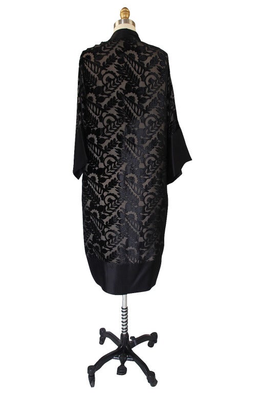 This robe was carefully stored and is in extraordinary condition. The fabric is strong and it is a wonderfully constructed garment. This is a stunning robe that has a beautiful black velvet pattern on a silk chiffon base. This is layered over an