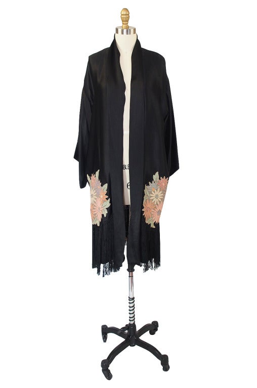 This robe was carefully stored and it shows as it is still in extraordinary condition! The fabric is strong and wearable and it is a high end, excellently constructed garment. This amazing robe is made of a beautiful and fine black silk. It has