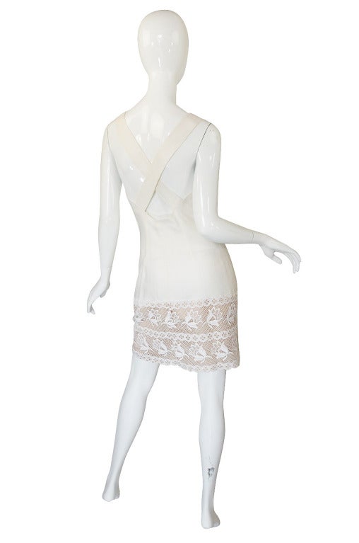 Classic Valentino! It is made of a white linen which was a favored fabric and incorporates a wide swath of embroidered lace at its hem - again a Valentino signature! I love the cut - it slims the body without being overtly tight. The back is left
