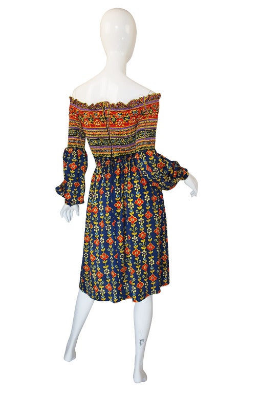 A remarkable Oscar de La Renta dress from 1971 as documented in US Vogue! Made of a poly jersey it has a simple, heavily elasticized bodice like a tube top. This hugs the body until it gets to the waist and then the skirt flows out from there. The