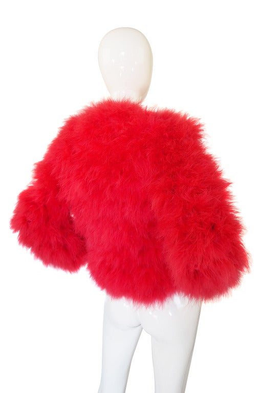 A wonderful hand dyed cherry red feather coat by Donald Brooks for Mainden Form made of soft ostrich feathers! The color against the crazy huge dotted black and white lining is just incredible! It's a pure candy color - think cherry popsicles in the