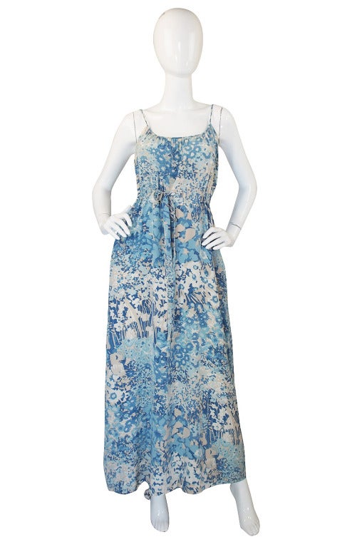This is an amazing and quite beautiful dress by Oscar de la Renta. It is really one of my favorites that I have had. A pale, pale baby blue floral design is masterfully screened onto two types of silk. The jacket is a silk chiffon and the dress is