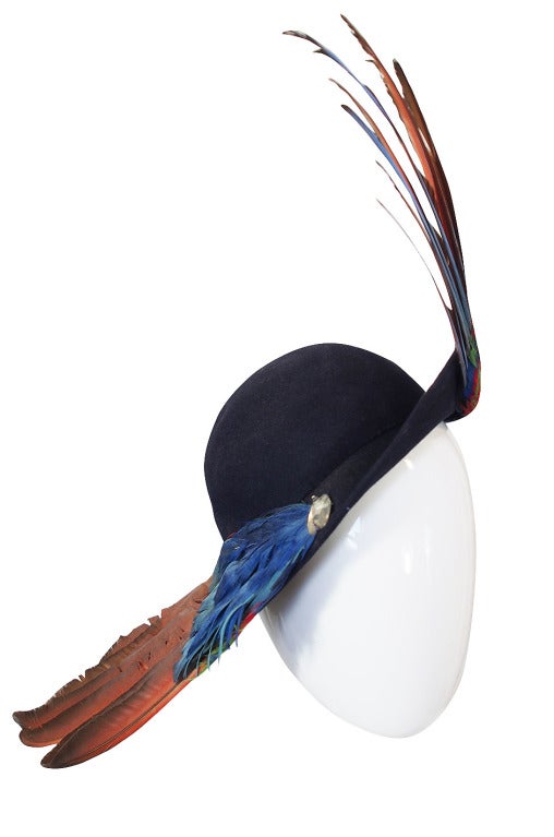 This late 1930s, early 1940s topper is pure high drama! Bes Ben was a famous Chicago milliner who specialized in hats that were elaborate and unusual. This is an early piece that is quite beautiful. A rounded cap has a neat, small half brim that