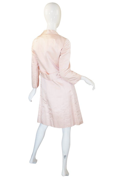 A stunning baby pink silk Malcolm Starr coat this is just divine. The silk has a slight texture running through it giving it a touch of visual interest. It closes neatly with a double row of buttons at the front and each button is covered in the
