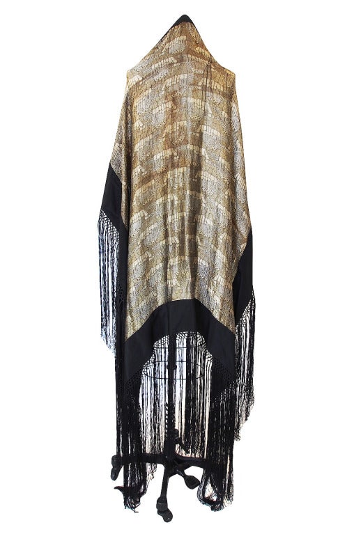 Showstopping, highly collectible 1920s real metallic gold and silver thread lame shawl is a masterpiece and really a work of art. It has the added decadence of silk fringe that makes it amazing! The entire surface has an almost reptile skin feel to