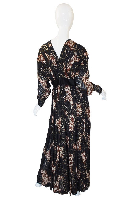 This amazing couture creation from James Galanos from an absolutely amazing textile! The silk on this gown is feather light and has a beautiful design in black, cream and a brown clay color woven into it. Through this is highlights of gold thread