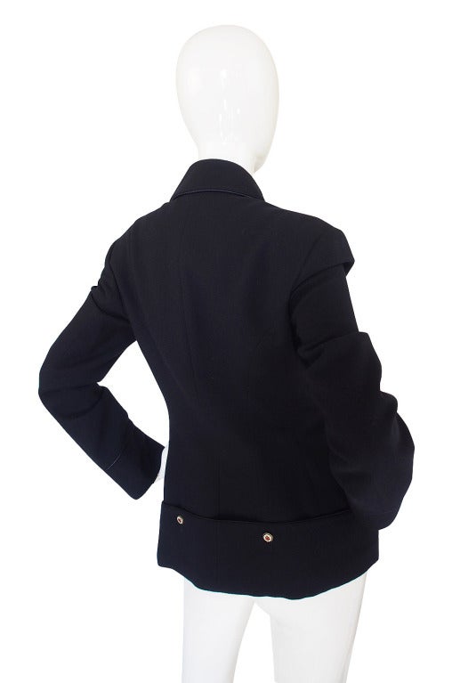 This is the same jacket as shown in Look 19 of the Fall 2008 McQueen show and it spectacular! On the runway it was styled with a huge skirt and high collared white shirt. A deep navy supports the Military feel of this piece. It is cut with the