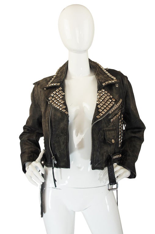 Perfectly broken in this vintage Motocross leather jacket is one of the originals behind a major trend happening on the current runways. The leather is a thick biker weight leather that has been distressed to a silvery grey hue. Heavy studs cover