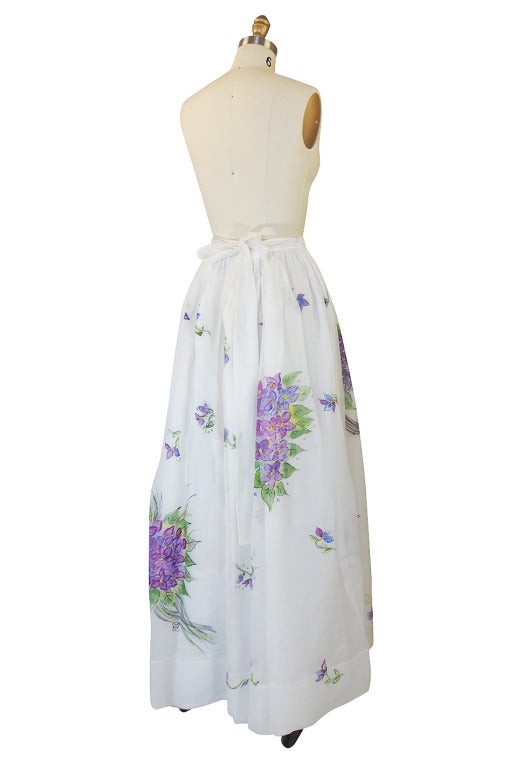 What an absolutely wonderful piece! Layers of silk organza float over each other on this pretty floor length skirt. The very top layer is hand painted with sweet bouquets of lavender flowers. It would work for the day or into the evening and is a