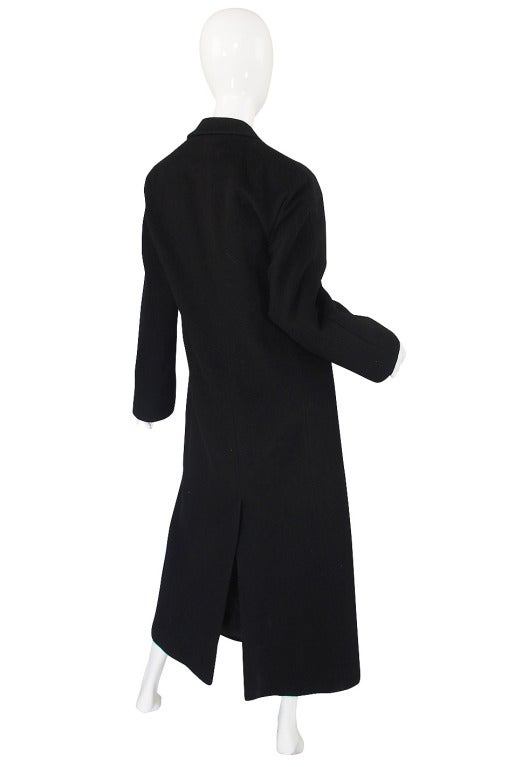Calvin Klein has always been the leader when it comes to this minimalist look and this coat is an essential if you love that aesthetic. Made of a black 100% merino wool it is cut in one long narrow sheath. I love the seamless shoulders and the nod