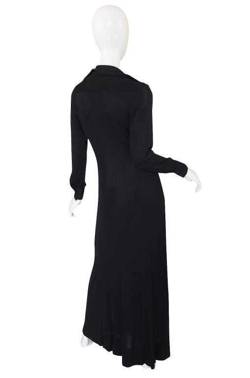 This 1972 dress is the black version of the one peeking above Halston's shoulder in the picture included in this listing. These long silk knit shirt dresses were a Halston staple and were designed for that chic modern woman to wear while
